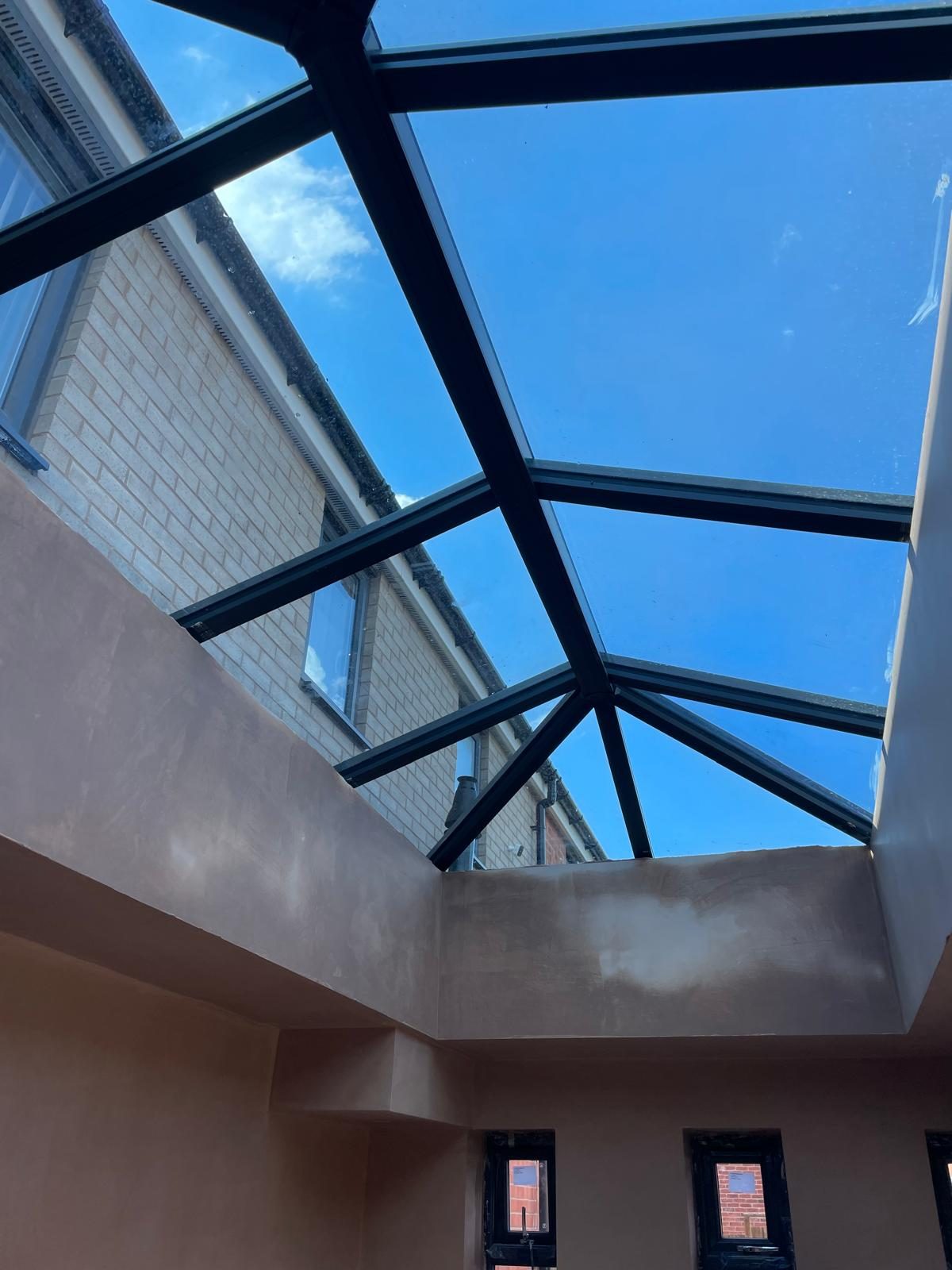 View up through an orangery roof lantern to blue sky in Staffordshire