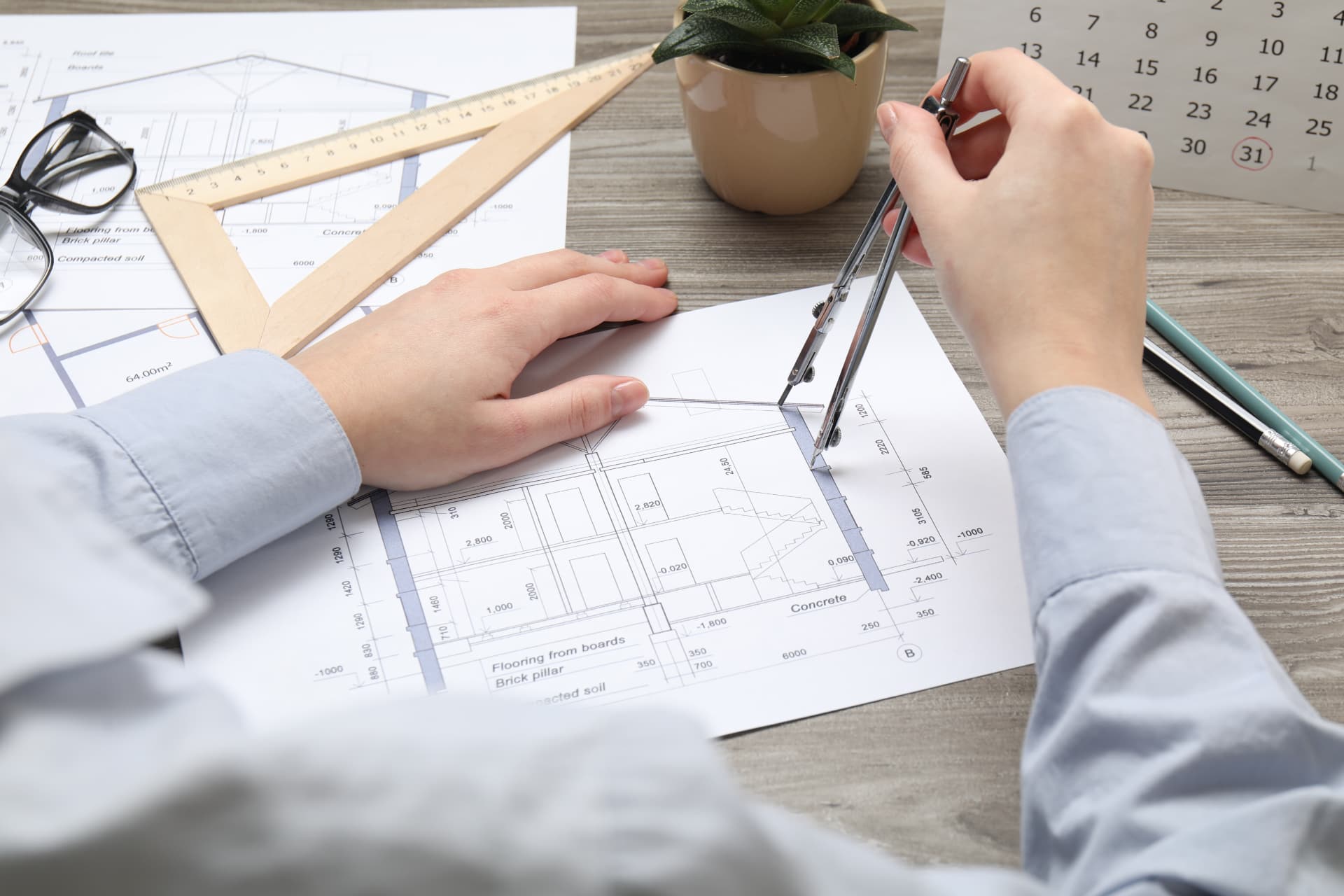 Architectural drawings and technical plans being set out with drawing instruments