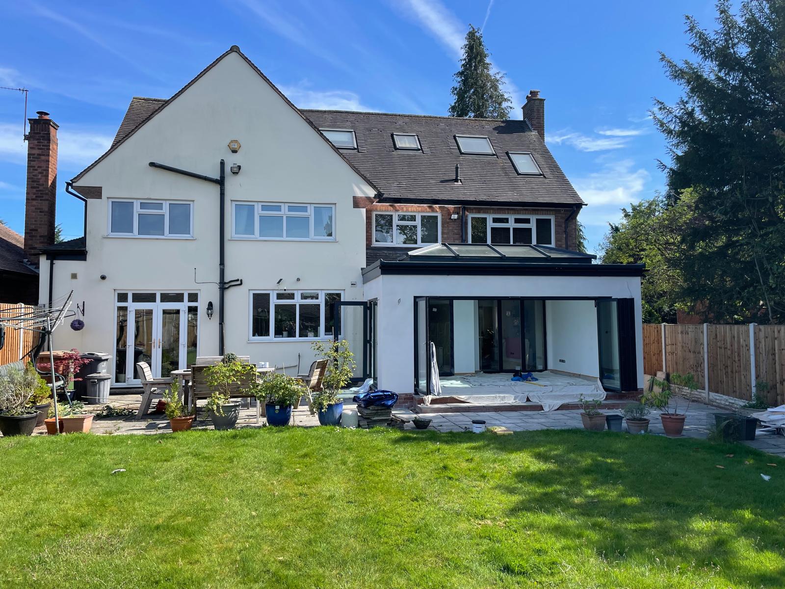 Completed single storey rear extension with glazed roof lantern and anthracite bi-fold doors