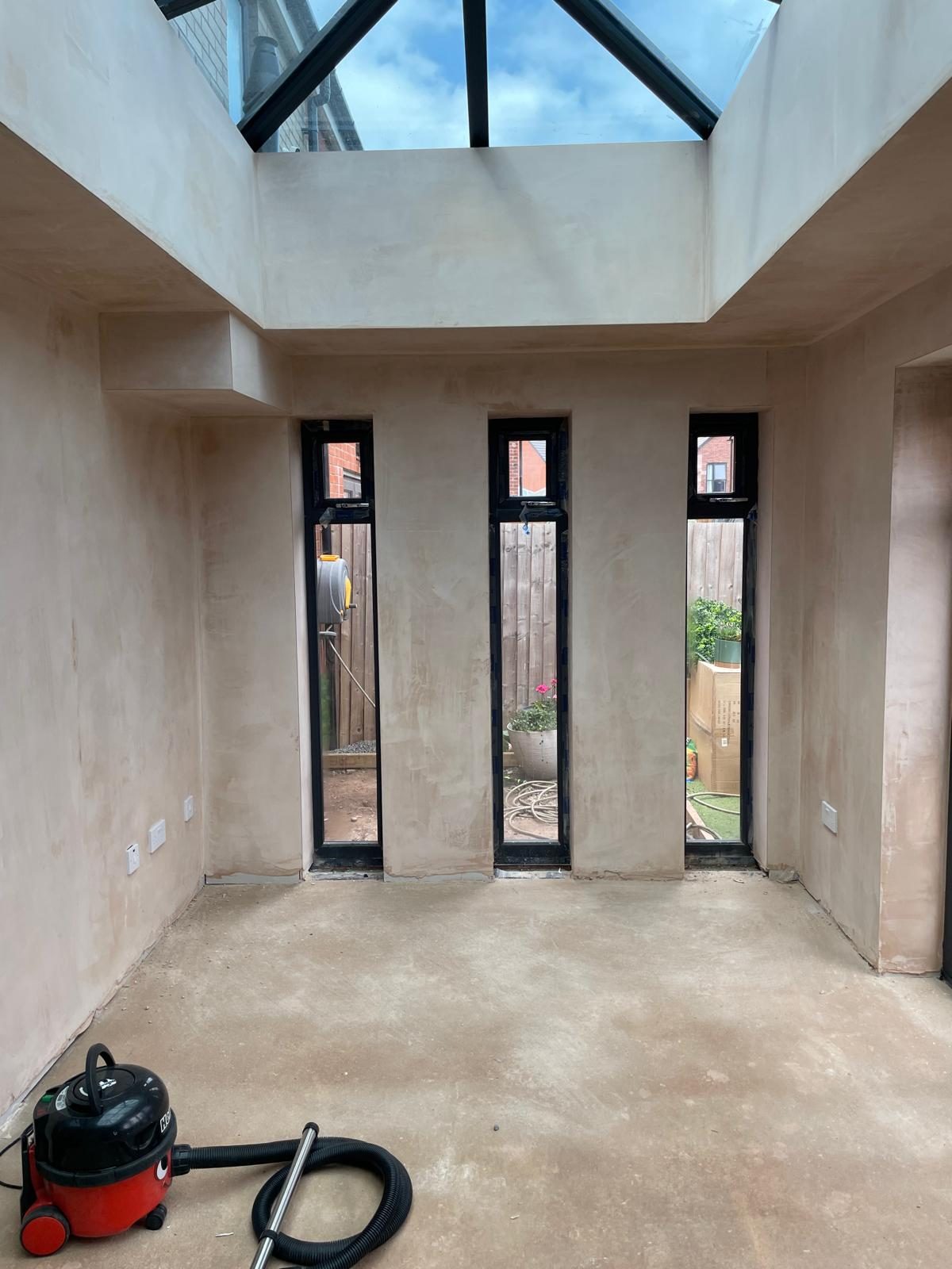 Orangery interior with roof lantern, tall windows and plastered walls in Cannock