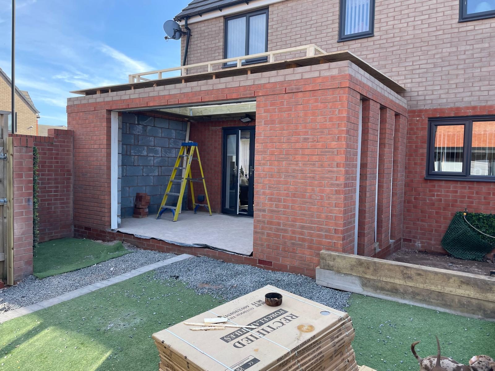 Brick orangery shell with flat roof structure built onto a Staffordshire home